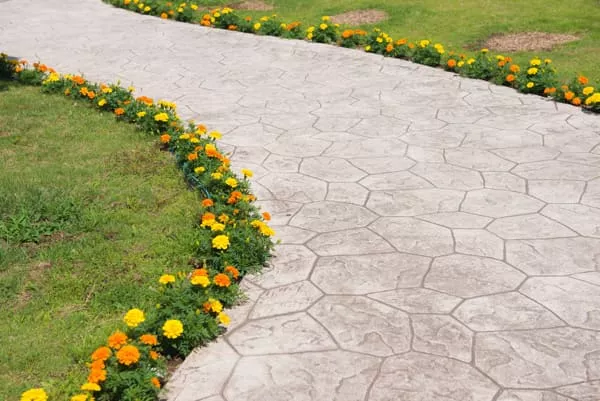 stamped concrete walkway with garden